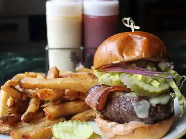 Burger with bacon and fries at the Farmhouse in Williston. 